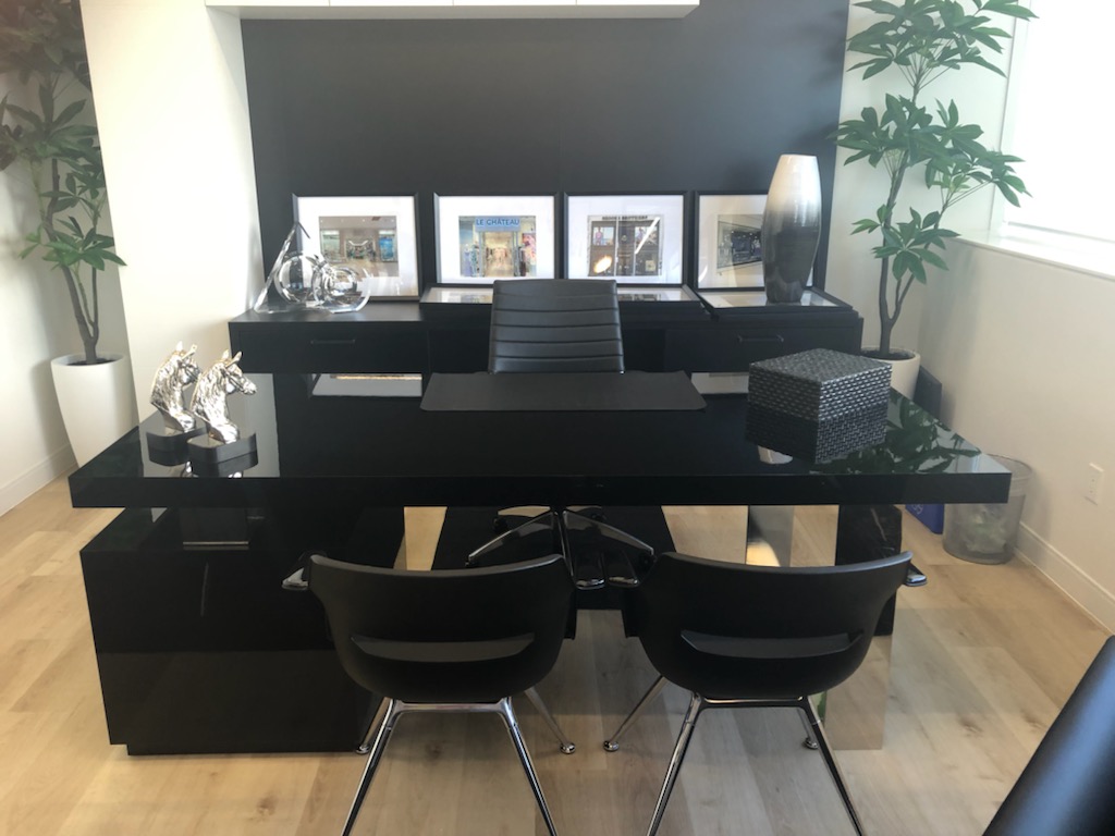 YM Inc executive office featuring a custom high-gloss black lacquer desk and built-in credenza by Leewood Finishing
