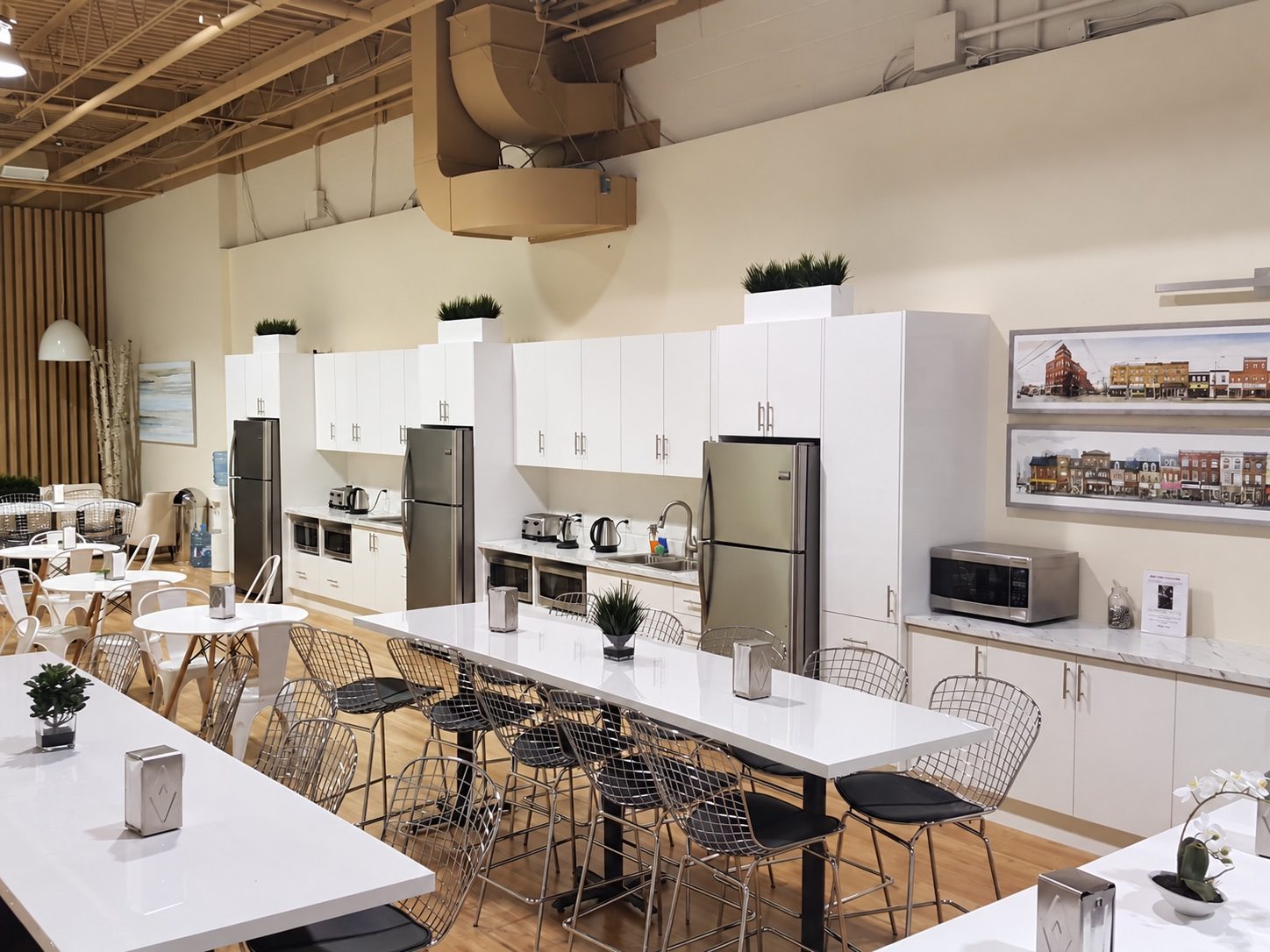 Staff cafeteria at a Toronto head office with white cabinetry built by Leewood Finishing