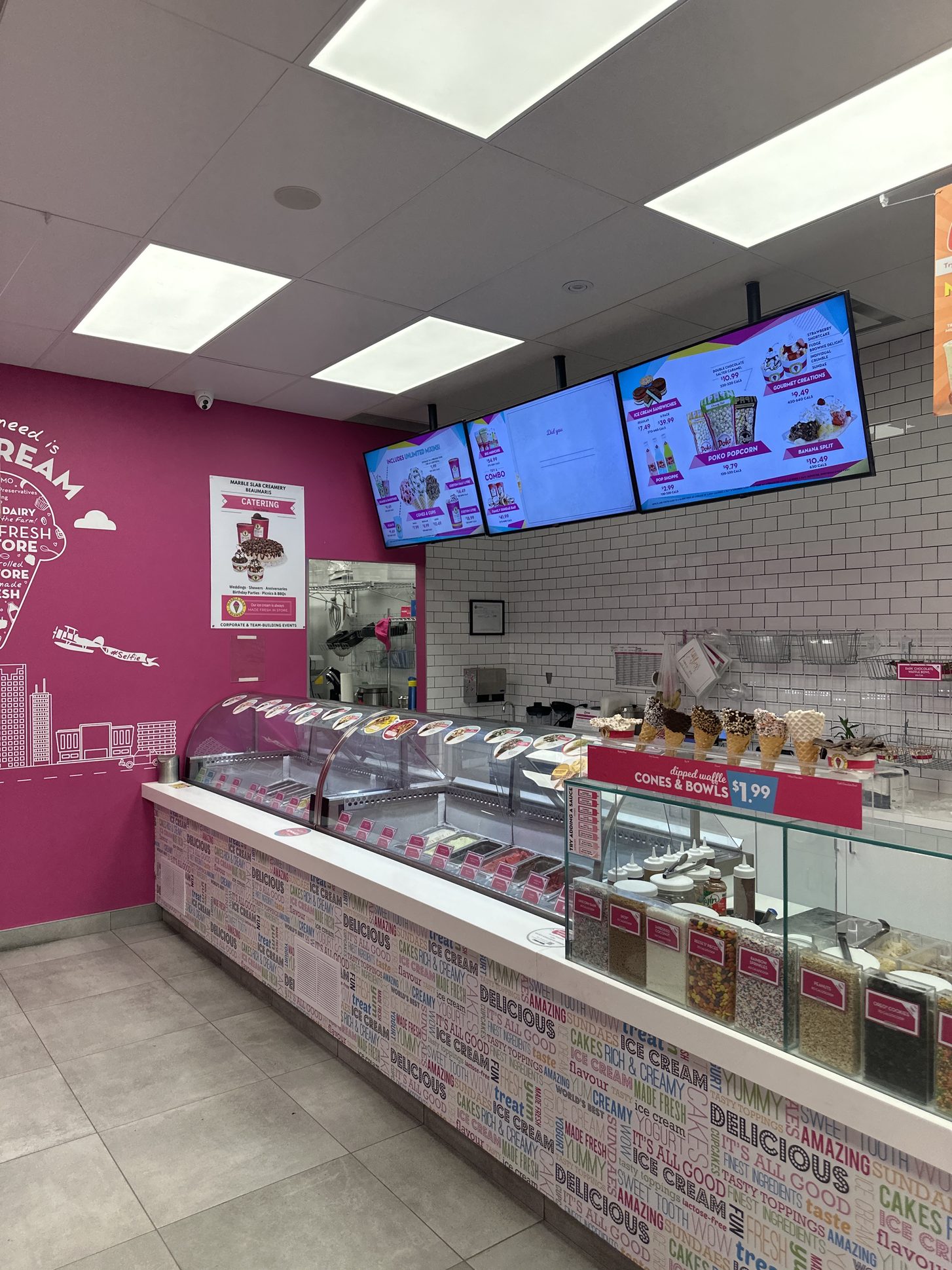Ice cream shop service counter in Brampton with cabinets and a solid-surface countertop built by Leewood Finishing
